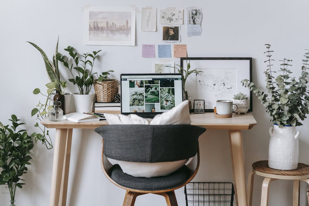 Modern home office setup with potted plants and decor, perfect for creativity and productivity.